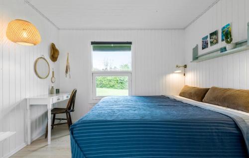 a bedroom with a bed and a desk and a window at 4 Bedroom Lovely Home In Rønde in Rønde