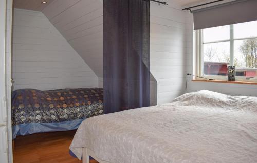 a bedroom with a bed and a window at Pet Friendly Apartment In Degeberga in Degeberga