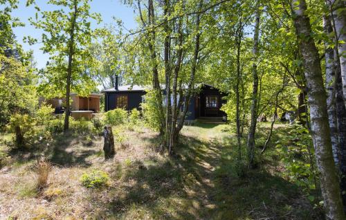 a cabin in the woods with trees in the foreground at Beautiful Home In Fur With Wifi in Fur