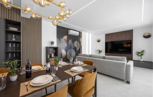 a dining room with a table and a couch at Me Paradise Villa Lavender in Tribunj