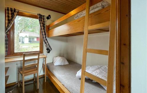 a bedroom with two bunk beds and a window at Amazing Home In Degeberga in Degeberga