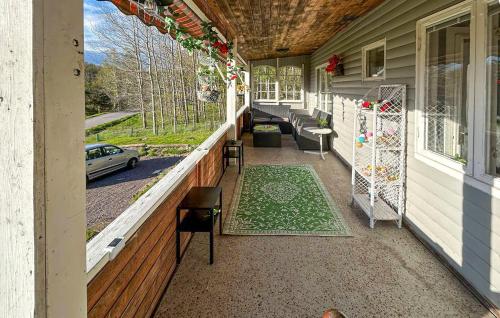 a porch of a house with a table and chairs at Pet Friendly Home In Söderköping in Söderköping