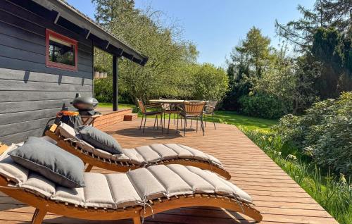 a wooden deck with chairs and a table on a patio at 2 Bedroom Amazing Home In Præstø in Præstø