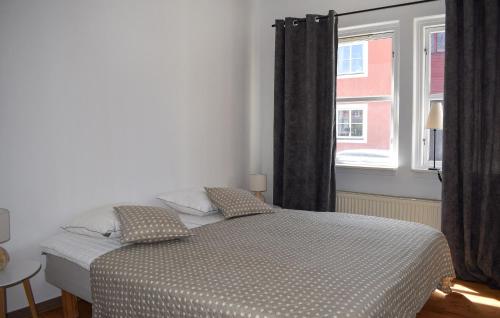 a bedroom with a bed and a large window at 2 Bedroom Awesome Apartment In Ystad in Ystad