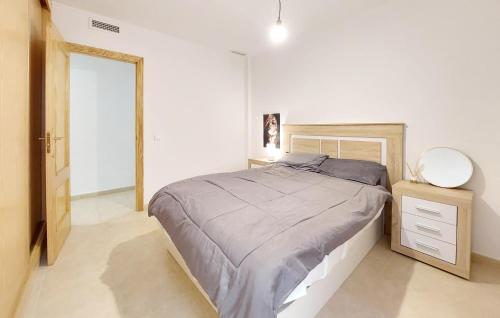 a white bedroom with a bed and a mirror at 2 Bedroom Gorgeous Apartment In Moncofa in Moncófar