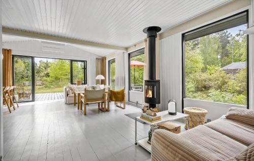 a living room with a couch and a fireplace at 3 Bedroom Gorgeous Home In Højby in Højby