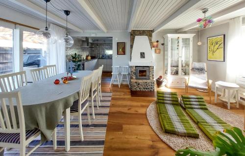 a dining room with a table and a fireplace at Amazing Home In Höganäs in Höganäs