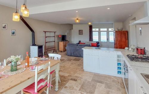 a kitchen and living room with a table and a couch at Gorgeous Home In Dognen With Wifi in Dognen