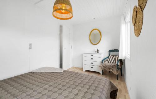 a bedroom with a bed and a dresser and a mirror at 2 Bedroom Amazing Home In Kerteminde in Kerteminde