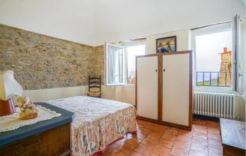 a bedroom with a bed and a cabinet and windows at Stunning Home In Costarainera in Costarainera