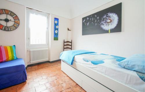 a bedroom with a bed and a clock on the wall at Stunning Home In Costarainera in Costarainera