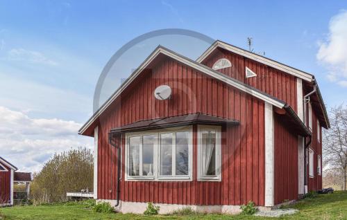 a red house with a round window on it at 4 Bedroom Stunning Home In Åtvidaberg in Åtvidaberg