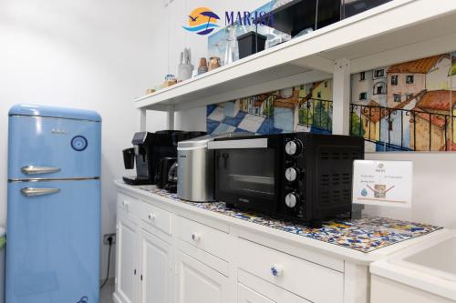 a kitchen counter with a microwave and a refrigerator at MAR-ISA Amalfi Coast in Vietri sul Mare