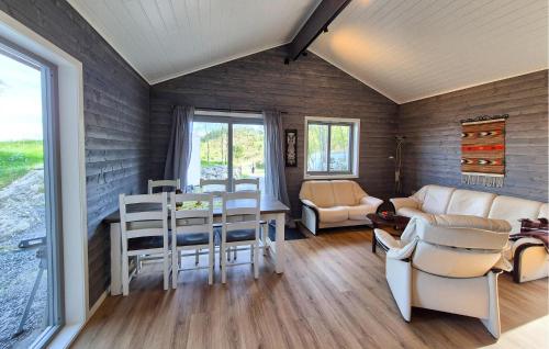 a living room with a couch and a table at Awesome Home In Sletta With Wifi in Sletta