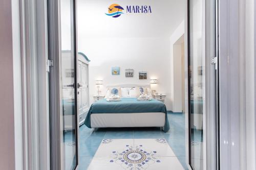 a bedroom with a bed and a mirror at MAR-ISA Amalfi Coast in Vietri sul Mare