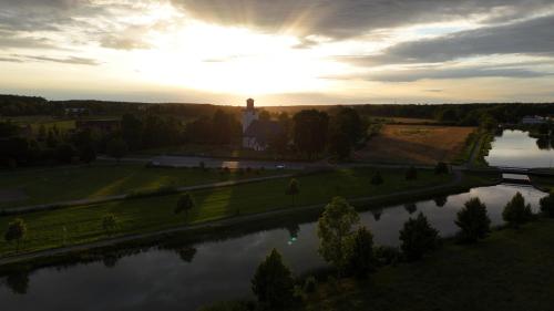 an aerial view of a river with the sun setting at SJÖTORPS HOSTEL in Sjötorp