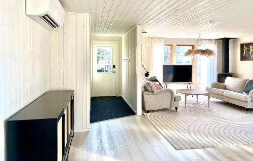a living room with a couch and a tv at Beautiful Home In Gräddö in Gräddö