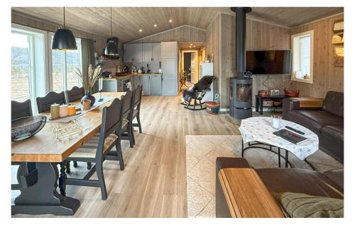 a kitchen and a living room with a dog in a room at 4 Bedroom Nice Home In Åmli in Åmli