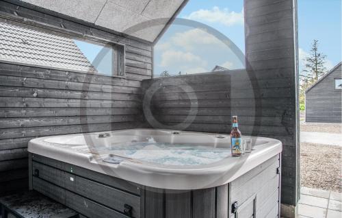 a bath tub with a bottle of beer in it at Awesome Home In Glesborg With Wifi in Glesborg