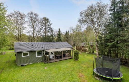 a small green house in the middle of a yard at Lovely Home In Hadsund With Wifi in Hadsund
