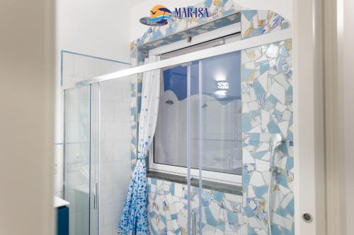 a bathroom with a shower with a tv in it at MAR-ISA Amalfi Coast in Vietri sul Mare