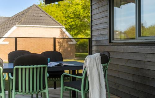 a table and chairs sitting on a porch with a table and chairs at 4 Bedroom Gorgeous Home In Oksbøl in Oksbøl