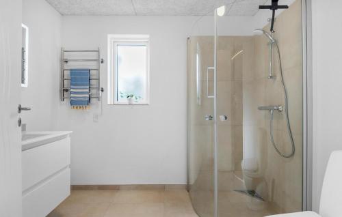 a bathroom with a shower with a glass door at 4 Bedroom Gorgeous Home In Oksbøl in Oksbøl