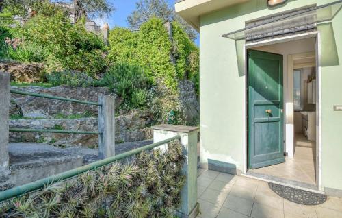 a green door on a building with a staircase at Nice Apartment In Recco With Wifi in Recco