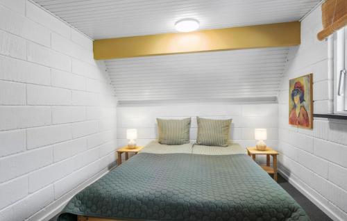 a bedroom with a bed and two lamps on tables at Lovely Home In Asperup in Asperup