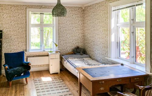 a bedroom with a bed and a desk and windows at Nice Home In Bolum With Wifi in Bolum