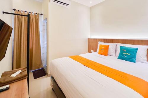 Кровать или кровати в номере Sans Vibes Millennium Garden Medan