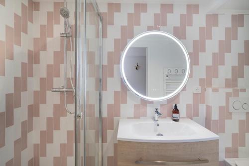 une salle de bain avec un lavabo et une douche avec un miroir dans l'établissement Monte Cristo - appt climatisé proche des plages, à Marseille