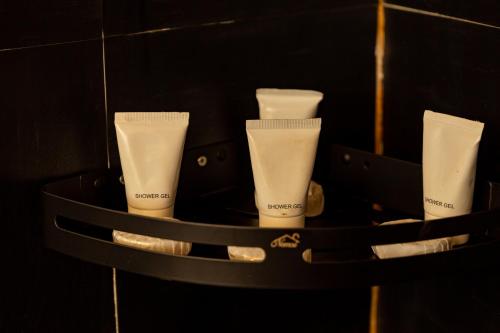 a black container with four tubes of cream in it at Olemayian Amboseli Cottages in Kimana