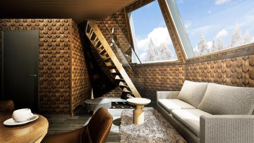 a living room with a couch and a window at Aurora Village Ivalo in Ivalo
