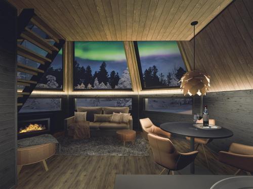 a living room with a couch and a table and a fireplace at Aurora Village Ivalo in Ivalo