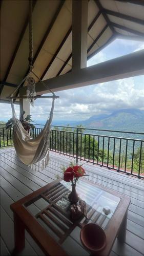 a hammock on a deck with a view of the ocean at Awesome Place in Ella