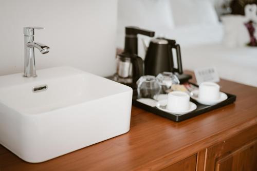 a white refrigerator sitting on top of a wooden counter at Lanna Inthan Resort in Doi Saket
