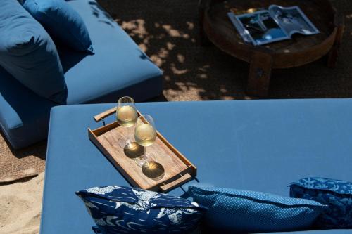 a wooden tray with spoons on top of a table at Clay Beach Samui - Beachfront Villas in Amphoe Koh Samui