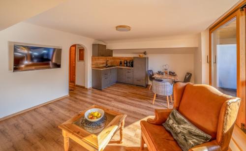 a living room with a couch and a table at Gästehaus Alpina in Krün