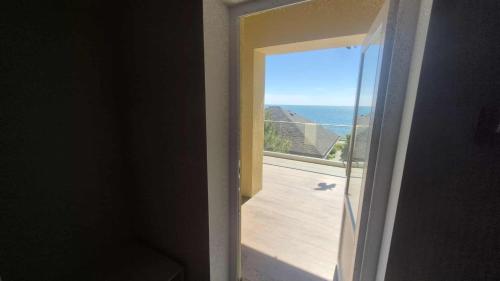a room with a view of the ocean from a window at Chayka Resort in Odesa