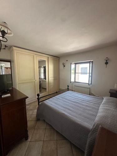a bedroom with a bed and a tv and a window at Villa Lelli 1 in Rome