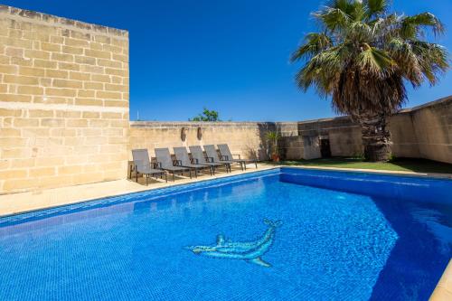 a swimming pool with a shark painted on it at Centre Island Holiday Home with private pool and hot tub in Kerċem