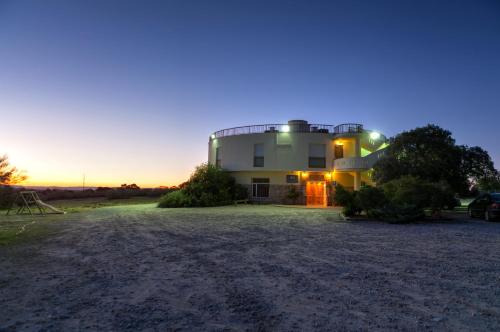a large house with a blue light on top of it at Hotel Paraje La Lambra in Rus
