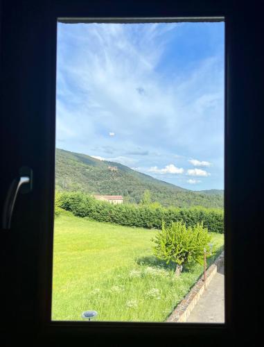 - une vue sur un champ d'herbe depuis une fenêtre dans l'établissement Restaurant des Amis, à Aujac