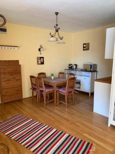 a kitchen and dining room with a table and chairs at Heviz Gracia Apartment in Hévíz