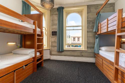 a bedroom with bunk beds and a window at Haka House Auckland K'Road in Auckland