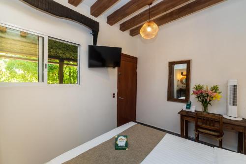 a bedroom with a bed and a mirror and a window at Collection O Casa Anzures Thematic, Mexico City in Mexico City