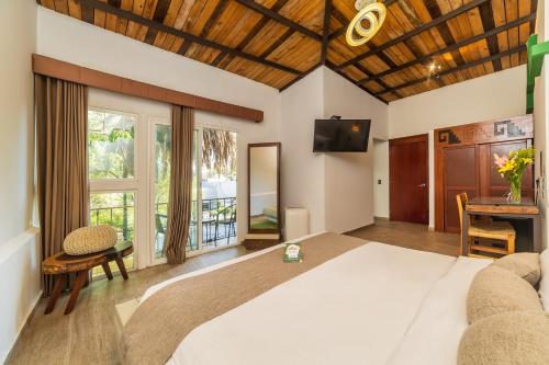 a bedroom with a large white bed and a table at Collection O Casa Anzures Thematic, Mexico City in Mexico City