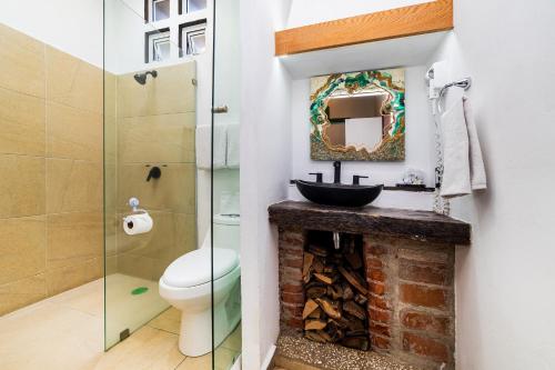 a bathroom with a sink and a toilet and a mirror at Collection O Casa Anzures Thematic, Mexico City in Mexico City