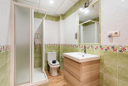a bathroom with a sink and a shower and a toilet at La Casita De La Playa in Cala del Moral